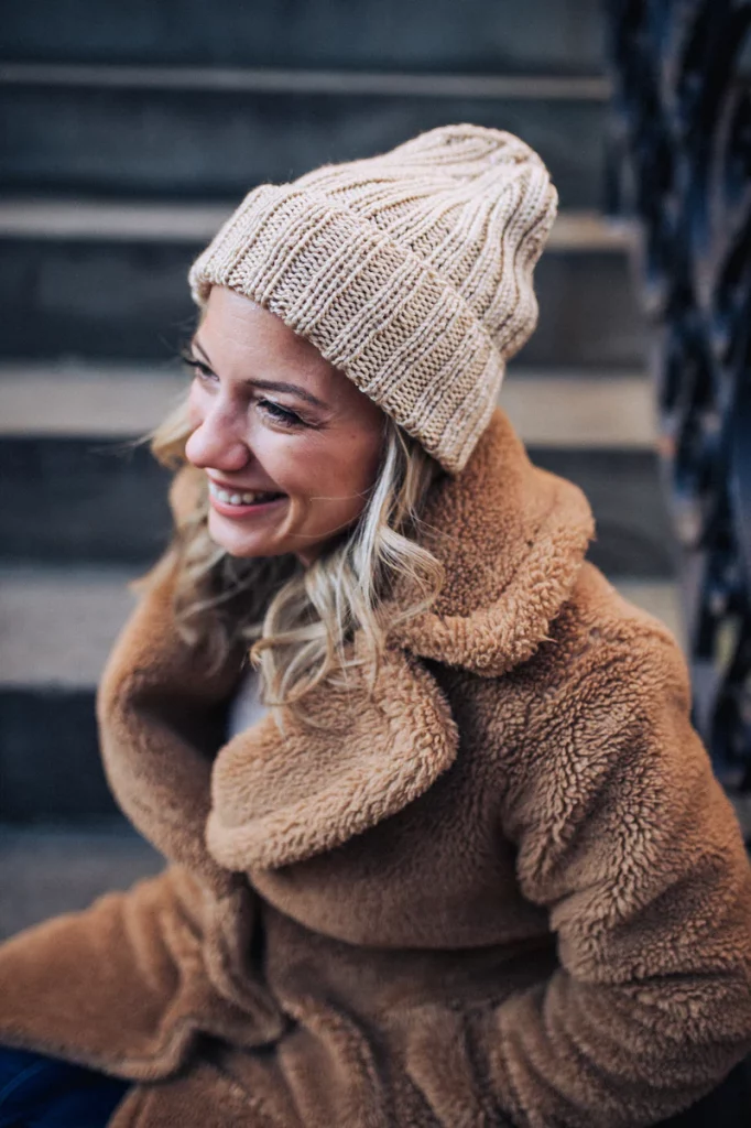 woman smiling in knitted beanie