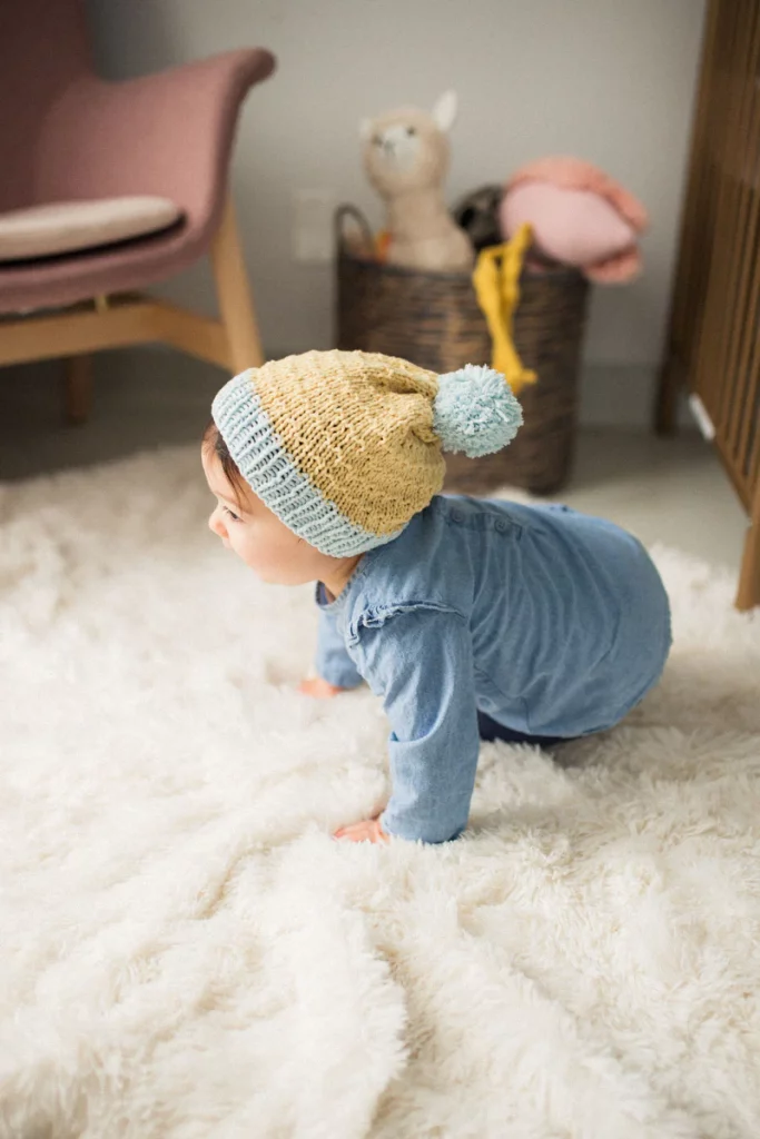 toddler wearing a beanie made from a free hat knitting pattern