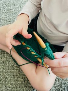 kid learning to knit