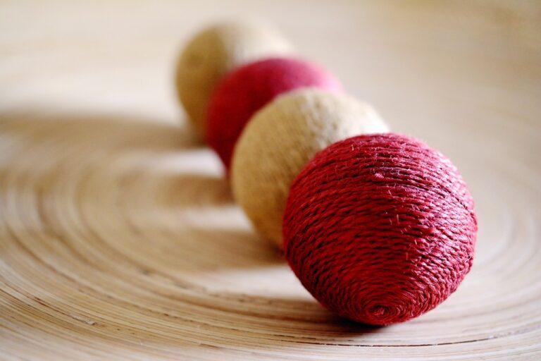 balls of yarn on a surface in holiday colors of red and cream