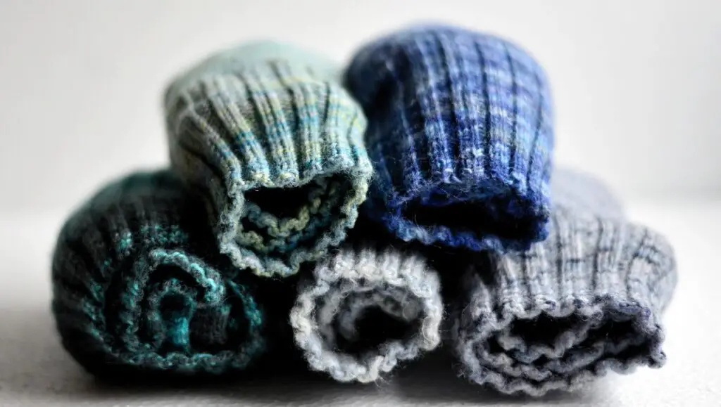 knit socks in cool holiday colors of gray blue and green